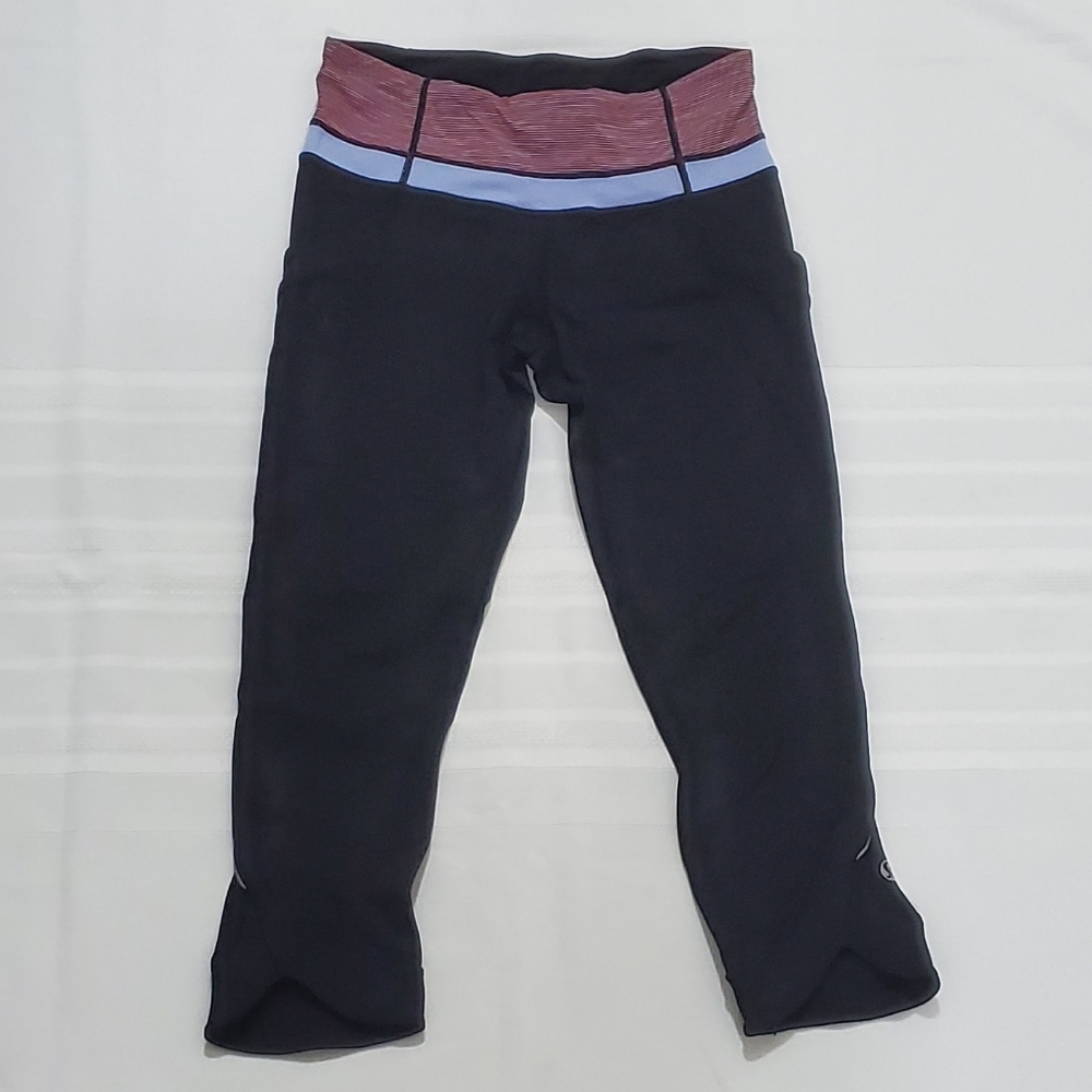 Lululemon black crop leggings with blue and pink at waist